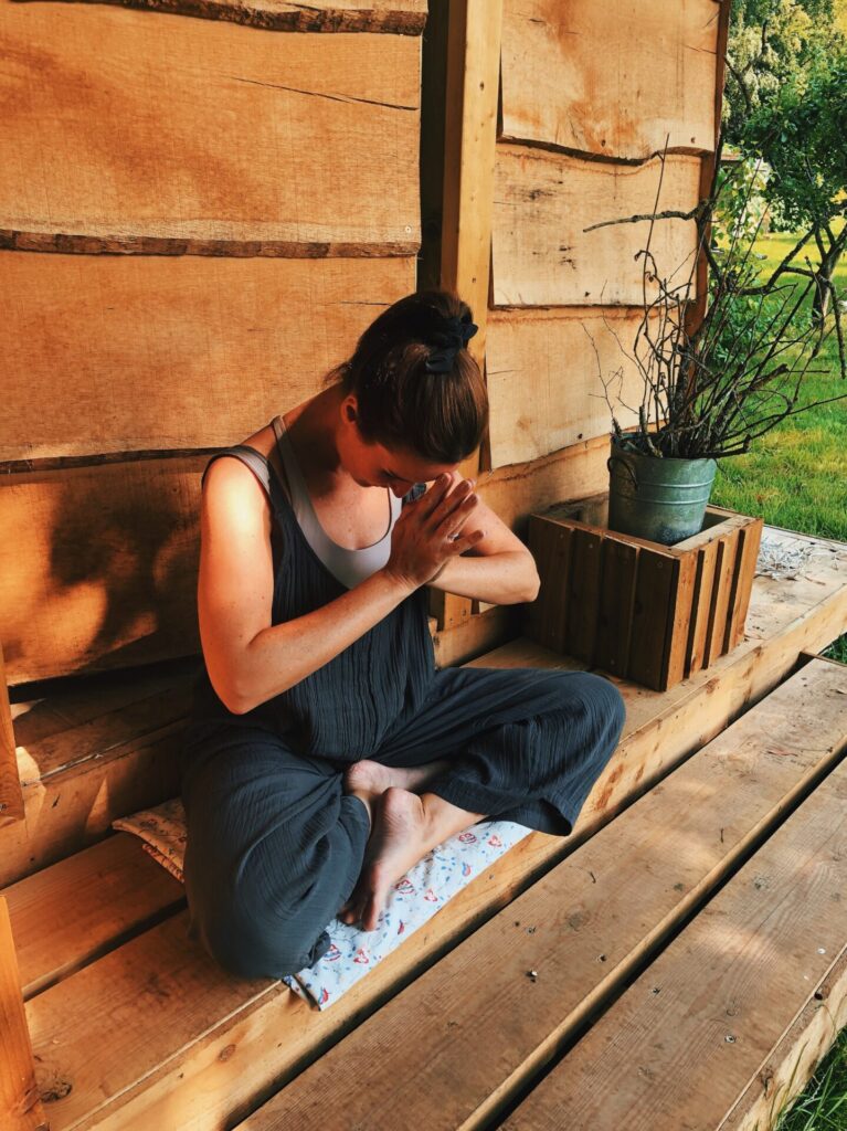 Gemma from Earth & Ether in seated yoga pose